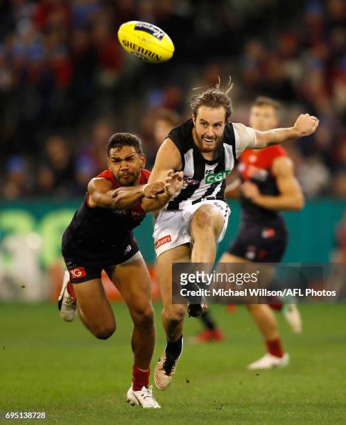 Tim Broomhead of the Magpies and Neville Jetta of the Demons in action during the 2017 AFL round 12 match between the Melbourne Demons and the...