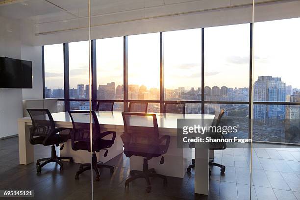 meeting room with glass wall cityscape and sunset - no people stock pictures, royalty-free photos & images
