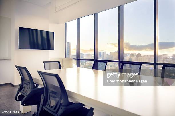 meeting room with view of cityscape sunset - meeting table stock pictures, royalty-free photos & images