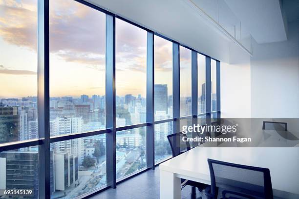 meeting room with window view of cityscape clouds - finestra foto e immagini stock