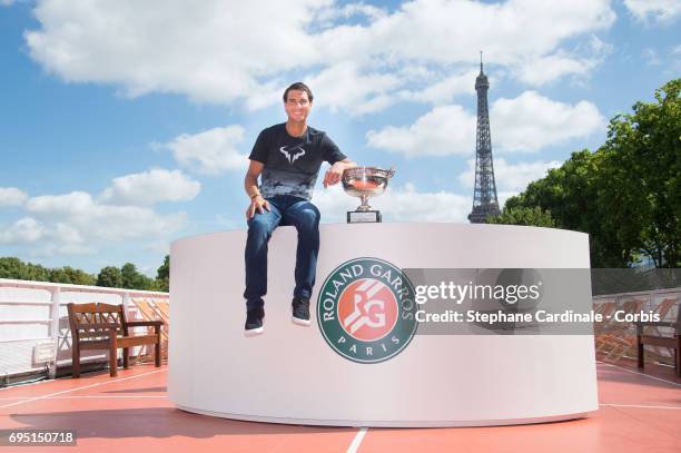 Rafael Nadal of Spain poses with the winner's trophy next to the Eiffel Tower during a photocall to celebrate his record breaking 10th French Open...