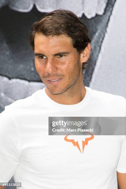 Rafael Nadal poses in front of a poster reading "Ten It's Rafa", refering to his tenth win at the French Tennis Open during a promotional event at...