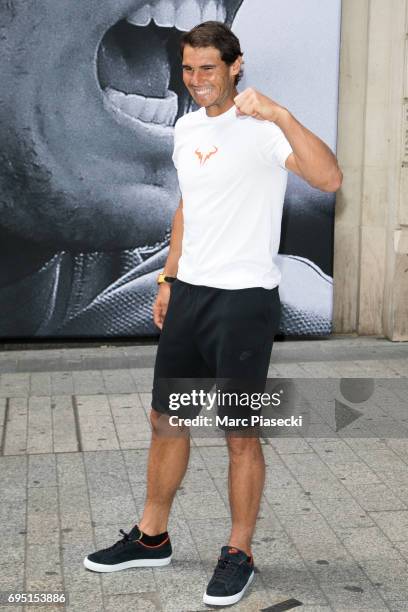 Rafael Nadal poses in front of a poster reading "Ten It's Rafa", refering to his tenth win at the French Tennis Open during a promotional event at...