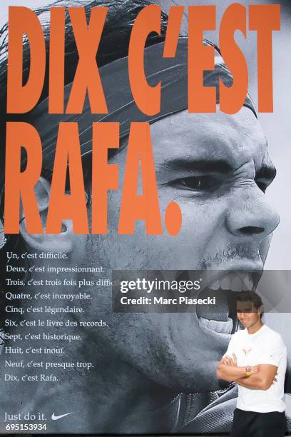 Rafael Nadal poses in front of a poster reading "Ten It's Rafa", refering to his tenth win at the French Tennis Open during a promotional event at...