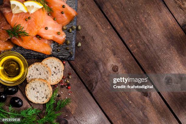 preparing smoked salmon canapes - smoked salmon stock pictures, royalty-free photos & images