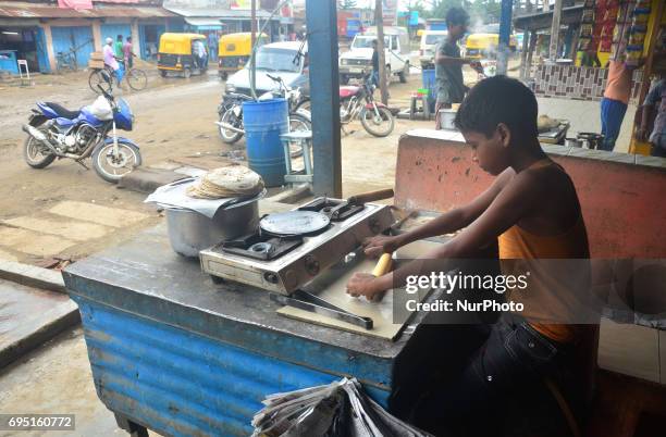 Eleven year-old Indian boy, Raju baked Roti at a roadside hotel on World Day Against Child Labour in Dimapur, India northeastern state of Nagaland on...