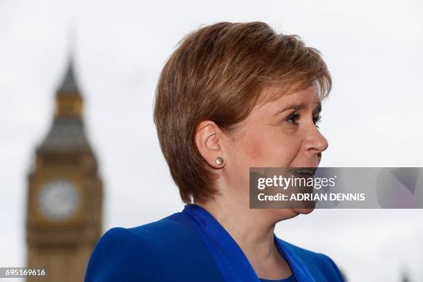 Scotland's First Minister and Scottish National Party leader Nicola Sturgeon speaks to members of the media in front of the Elizabeth Tower, commonly...