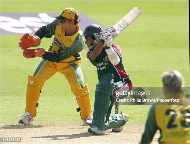 Mohammad Ashraful of Bangladesh hits out, watched by Australian wicketkeeper Adam Gilchrist during the NatWest Series One Day International between...
