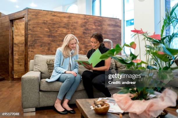 customer talking to the business owner at the spa - beautician client stock pictures, royalty-free photos & images