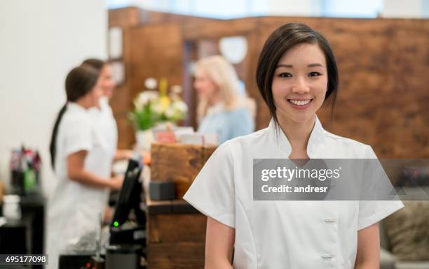 portrait of an asian woman working at a spa - beautician stock pictures, royalty-free photos & images