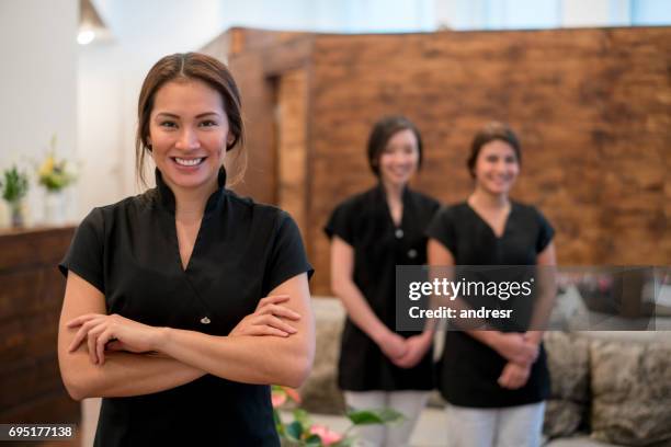 glückliche eigentümer in einem spa mit einer gruppe von arbeitnehmern - masseur stock-fotos und bilder