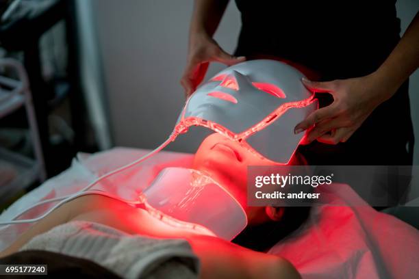 woman at the spa getting skin laser treatment - beauty laser stock pictures, royalty-free photos & images