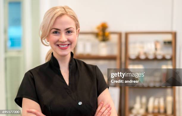 happy business owner working at a spa - tratamento de beleza ocupação imagens e fotografias de stock