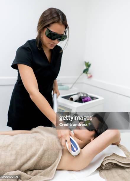 woman getting laser hair removal in her armpits - waxing hair removal stock pictures, royalty-free photos & images