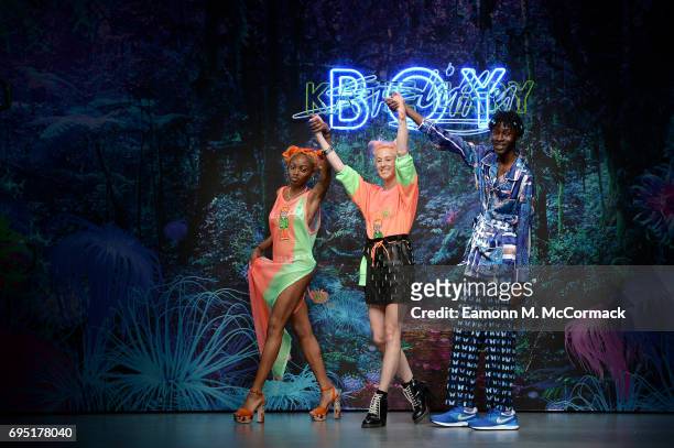 Designer Katie Eary salutes the crowd alongside models at the Katie Eary show during the London Fashion Week Men's June 2017 collections on June 12,...