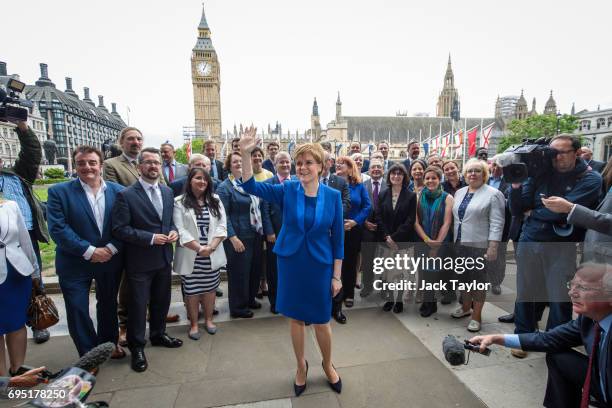 Scottish National Party Leader Nicola Sturgeon waves as she stands in front of SNP MPs elected in the general election during a photocall in...