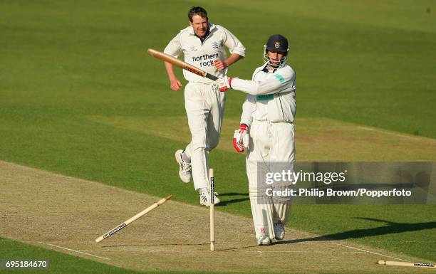 John Crawley of Hampshire knocks his off stump over after losing his middle stump during the County Championship match between Hampshire and...