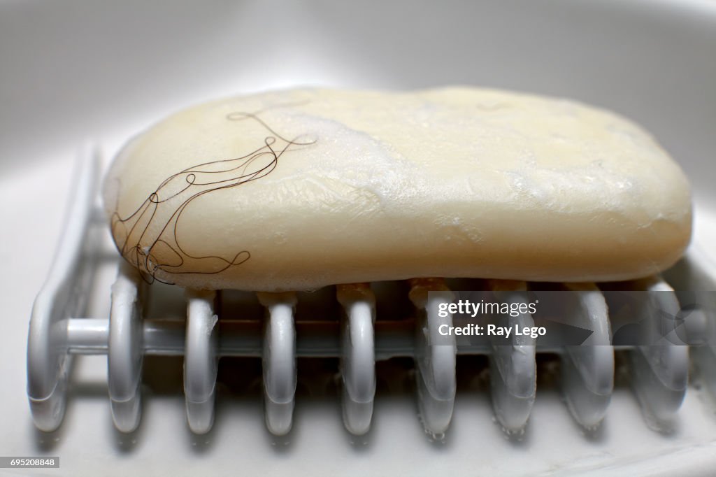 Bar soap in Bathroom with Hair on it.