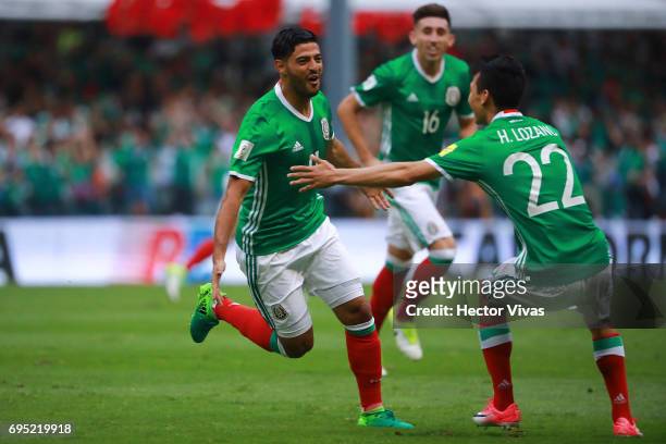 Carlos Vela of Mexico celebrates with teammates after scoring the first goal of his team during the match between Mexico and The United States as...