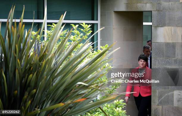 Leader Arlene Foster walks through a doorway as she makes her way towards a press conference at Stormont Castle as the Stormont assembly power...