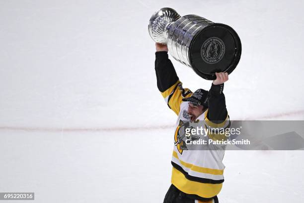 Sidney Crosby of the Pittsburgh Penguins celebrates with the Stanley Cup trophy after they defeated the Nashville Predators 2-0 to win the 2017 NHL...