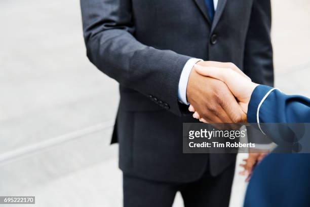 close up of business hand shake - handshake close up stock-fotos und bilder