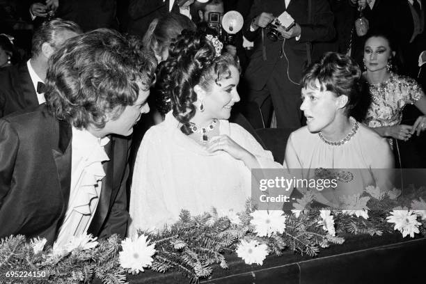 British actor Richard Burton his wife British American actress Elizabeth Tayor , and French actress Jeanne Moreau attend the UNICEF gala at the...