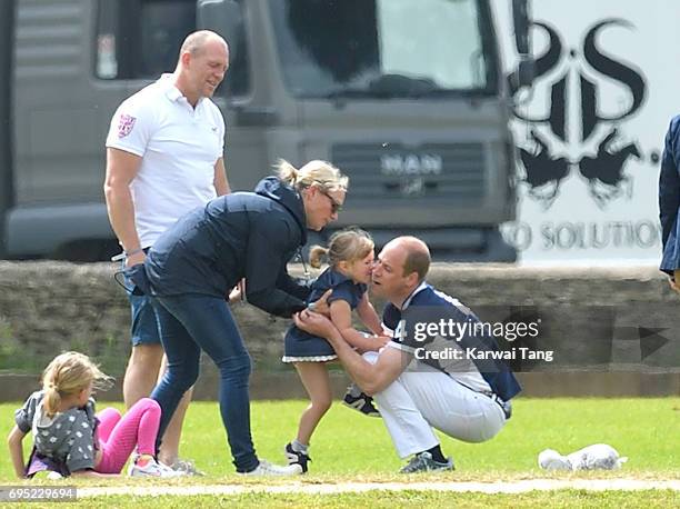 Mike and Zara Tindall watches daughter Mia get a hug from Prince William, Duke of Cambridge at the Maserati Royal Charity Polo Trophy at Beaufort...