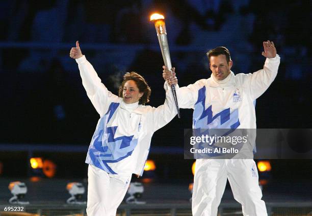 Gold medal speed skaters Bonnie Blair and Dan Jansen carry the olympic Torch towards the Olympic Flames cauldron at the Opening Ceremony of the 2002...