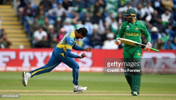 Sri Lanka bowler Nuwan Pradeep celebrates after dismissing Pakistan batsman Imad Wasim during the ICC Champions League match between Sri Lanka and...