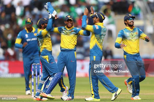 Niroshan Dickwella of Sri Lanka celebrates with team mates after taking a catch off the bowling of Nuwan Pradeep to dismiss Imad Wasim of Pakistan...