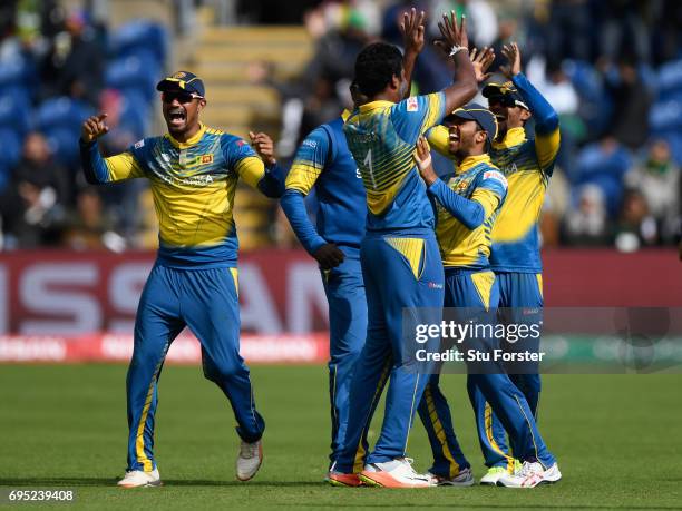 Sri Lanka bowler Thisara Perera is congratulated after running out Pakistan batsman Fahim Ashraf by deflecting a shot onto his stumps during the ICC...