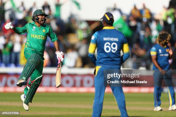 Sarfraz Ahmed of Pakistan celebrates hitting the winning runs and victory by 3 wickets as Sri Lanka captain Angelo Mathews looks on during the ICC...