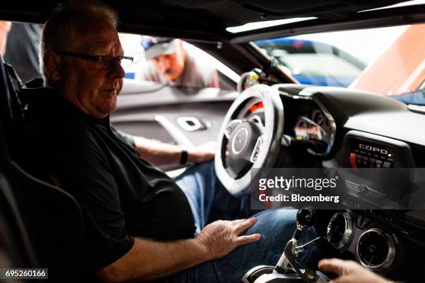 Lottery winner Kevin Mitchell sits inside his new General Motors Co. Chevrolet COPO Camaro performance vehicle during a tour of the build center in...