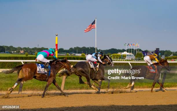 Jockey Rajiv Maragh on Irish War Cry leading turn 4 with jockey Jose Ortiz on Tapwrit and jockey Victor Espinoza on Gormley chasing during The 149th...