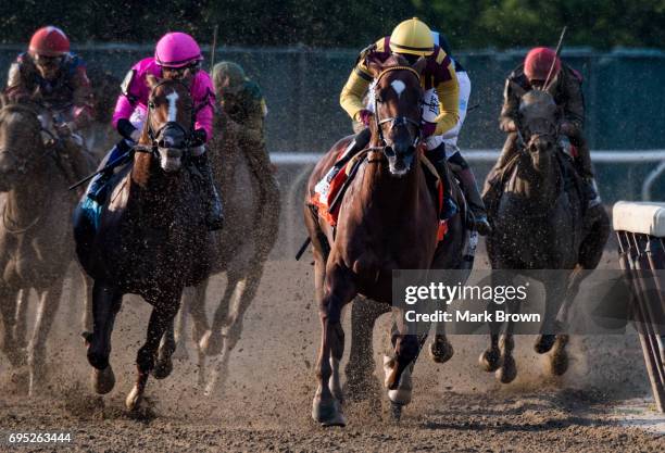 Jockey Rajiv Maragh on Irish War Cry leading turn 3 with jockey Mike Smith on Meantime chasing during The 149th running of the Belmont Stakes at...