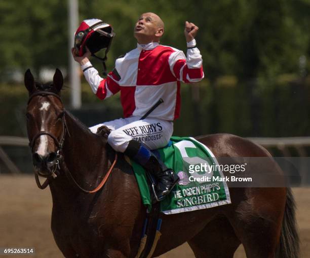 Jockey Mike Smith on Songbird celebrates winning The Ogden Phipps during The 149th running of the Belmont Stakes at Belmont Park on June 10, 2017 in...