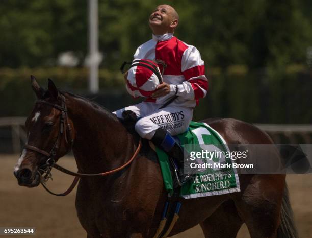 Jockey Mike Smith on Songbird celebrates winning The Ogden Phipps during The 149th running of the Belmont Stakes at Belmont Park on June 10, 2017 in...
