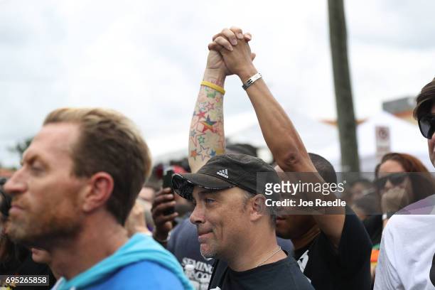 People mourning the loss of family, friends and loved ones in the mass shooting at the Pulse gay nightclub gather together outside the club during a...