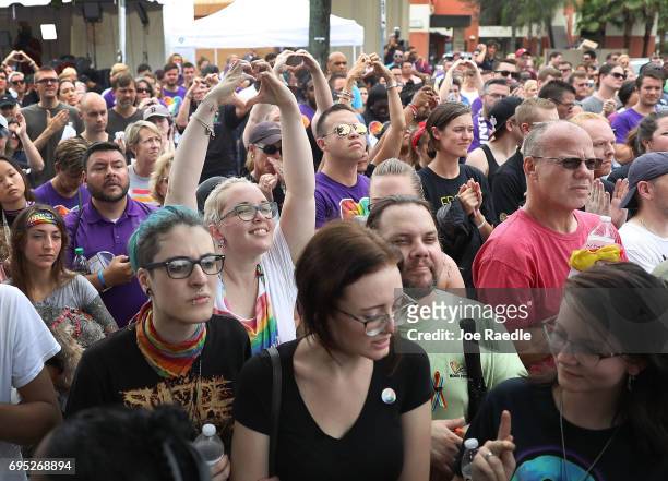 People mourning the loss of family, friends and loved ones in the mass shooting at the Pulse gay nightclub gather together outside the club during a...