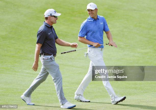 Jordan Spieth of the United States talks to coach Cam McCormick during a practice round prior to the 2017 U.S. Open at Erin Hills on June 12, 2017 in...