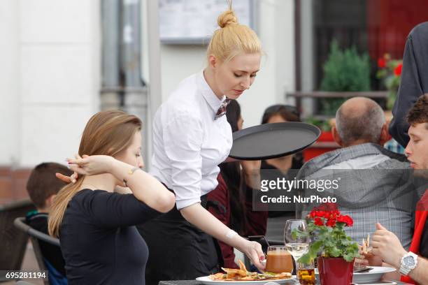 People are seen dining outside at the Karramba restaurant on the old market square in Bydgoszcz, Poland on 10 June, 2017.