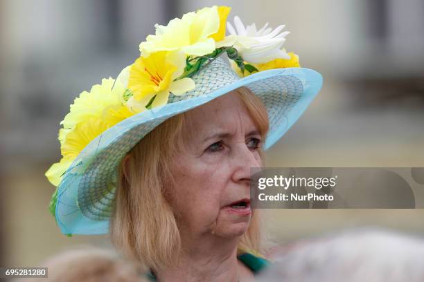 Woman with a flower hat is seen in the center of the old city on 10 June, 2017.