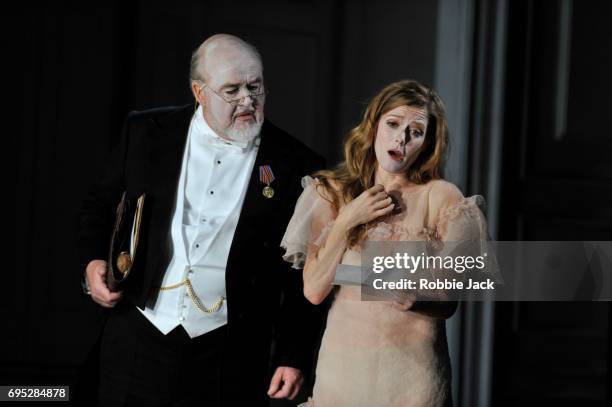 Kim Begley as Polonius and Barbara Hannigan as Ophelia in Glyndebourne's production of Brett Dean's Hamlet directed by Neil Armfield and conducted by...