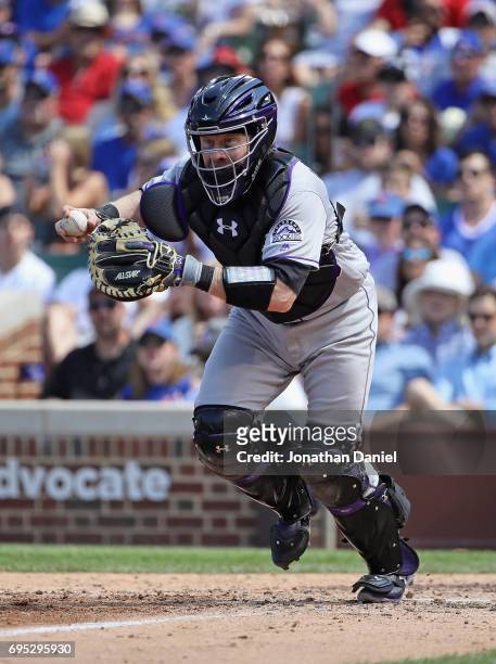 Ryan Hanigan of the Colorado Rockies chases a runner against the Chicago Cubs at Wrigley Field on June 9, 2017 in Chicago, Illinois. The Rockies...