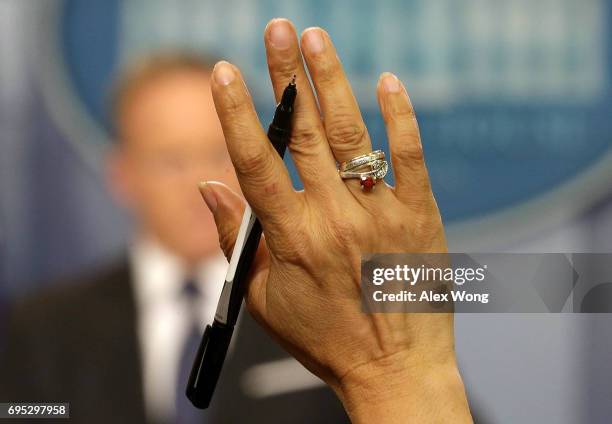 Reporter raises their hand to as a question of White House Press Secretary Sean Spicer at a White House daily briefing at the James Brady Press...