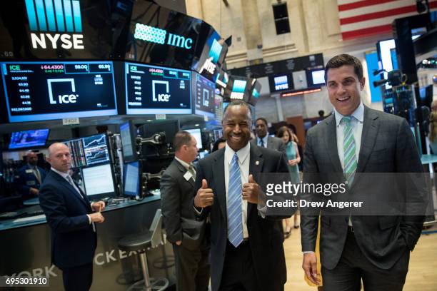 Secretary of Housing and Urban Development Ben Carson gives the thumbs up as he walks with Thomas Farley, president of the NYSE, as he tours the...