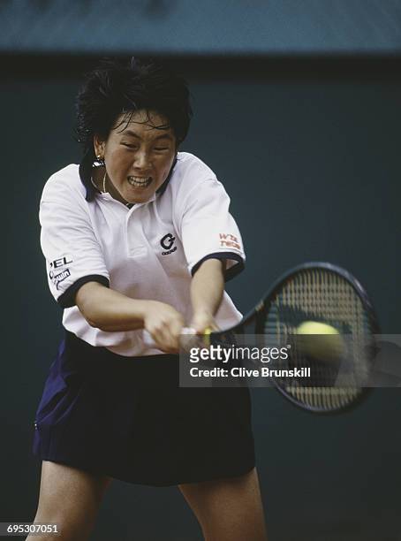 Ai Sugiyama of Japan eyes the ball as she returns against Jolene Watanabe during their Women's Singles third round match at the French Open Tennis...