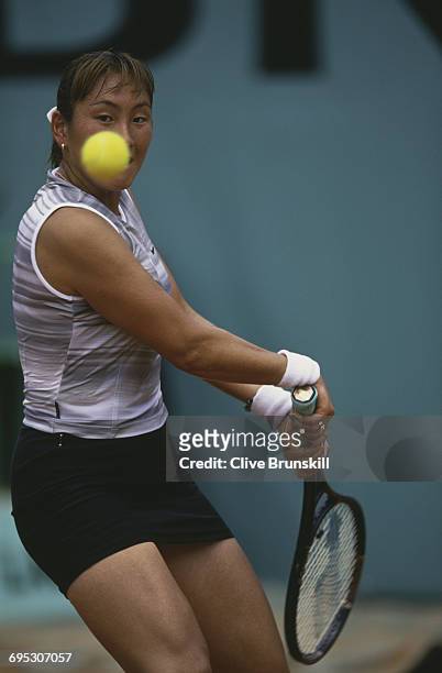 Ai Sugiyama of Japan eyes the ball as she returns against Sylvia Plischke during their Women's Singles third round match at the French Open Tennis...
