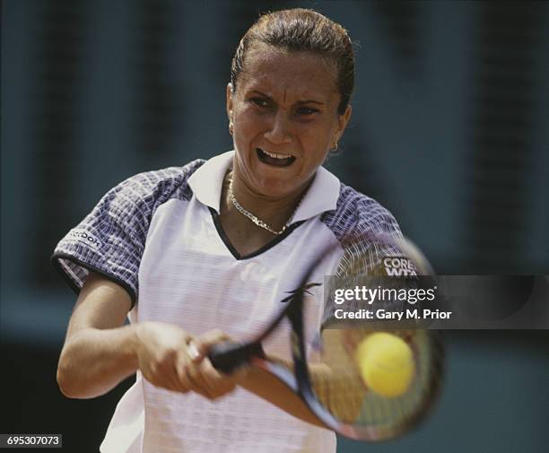 Iva Majoli of Croatia plays a backhand return to Martina Hingis during their Women's Singles Final match at the French Open Tennis Championship on 7...